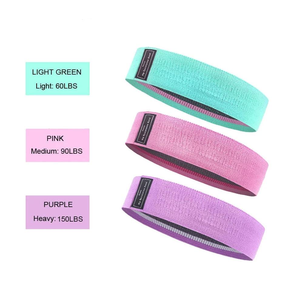 Blogger booty bands - accessories mint green, pink and purple exercise bands on display showing their weight-relative resistance. Light green is 60, pink is 90 & purple is 150lbs resistance.