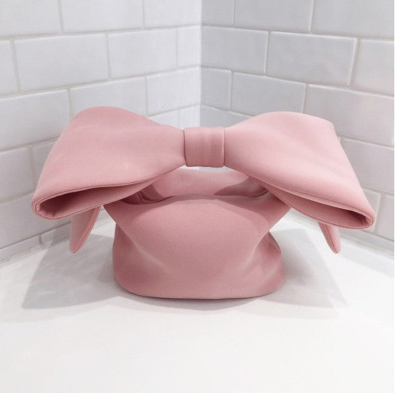 Pink Belle Bow Bag against soft grey background.