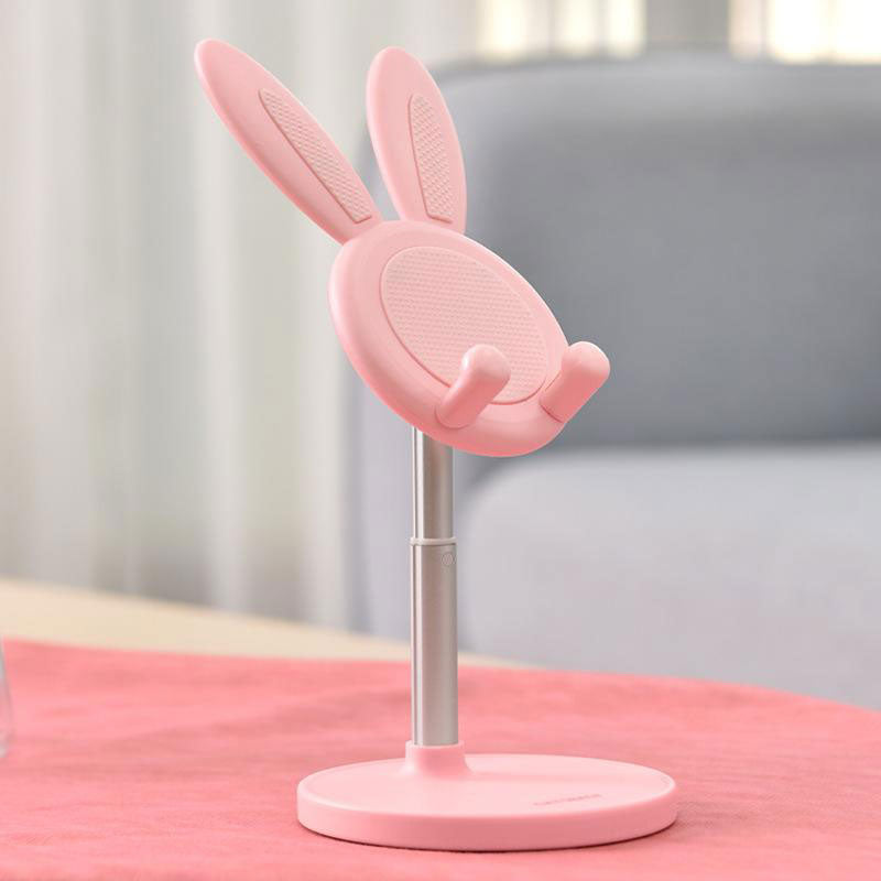 Pink Boston Bunny Phone Stand on pink cloth set against white and grey backdrop