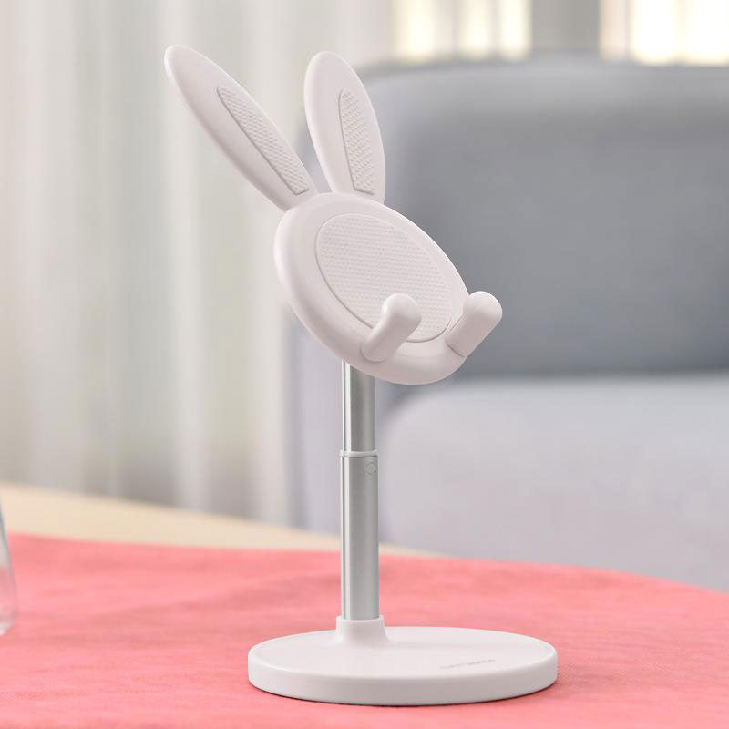 White Boston Bunny Phone Stand on pink cloth set against white and grey backdrop