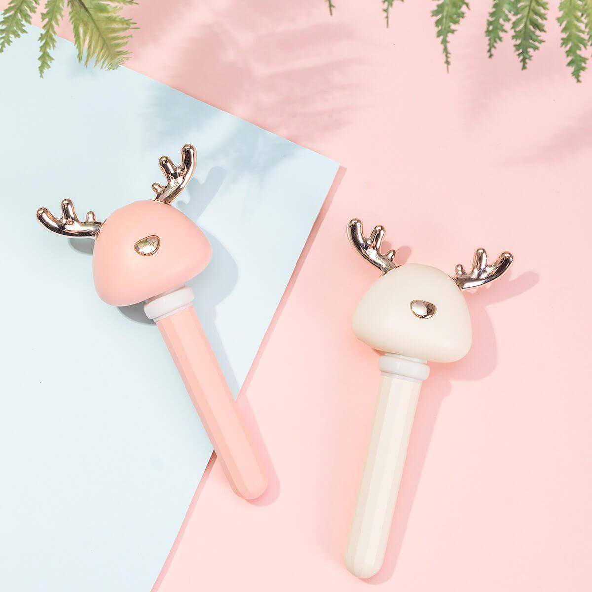 Pretty Flat lay of both Pink and White Ava portable humidifiers - Pink and Baby blue paper background 