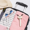 White Ava Portable Humidifier Laying on pink blanket in opened suitcase filled with travel items