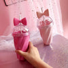 Hot Pink & Pink Belle bow cups on glitter covered table - star glittered transparent curtain in backround - home & office