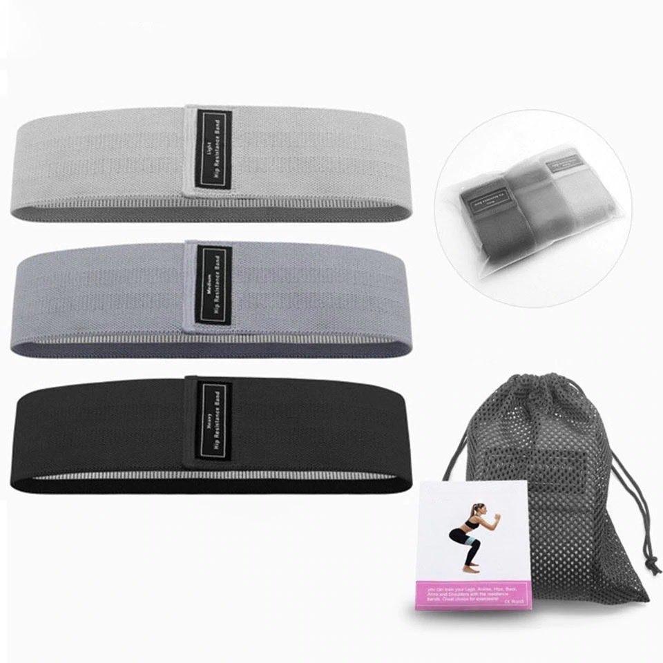 Blogger booty bands - grey - accessories Light gray, dark gray and black bands on display, and rolled in a clear plastic pouch. Mesh bag and instruction manual in the bottom right corner of pic