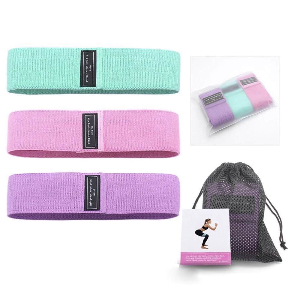 Blogger booty bands - pastel - accessories Mint green, cotton candy pink and light purple bands on display, and rolled in a clear plastic pouch. Mesh bag and instruction manual  in the bottom right corner of pic