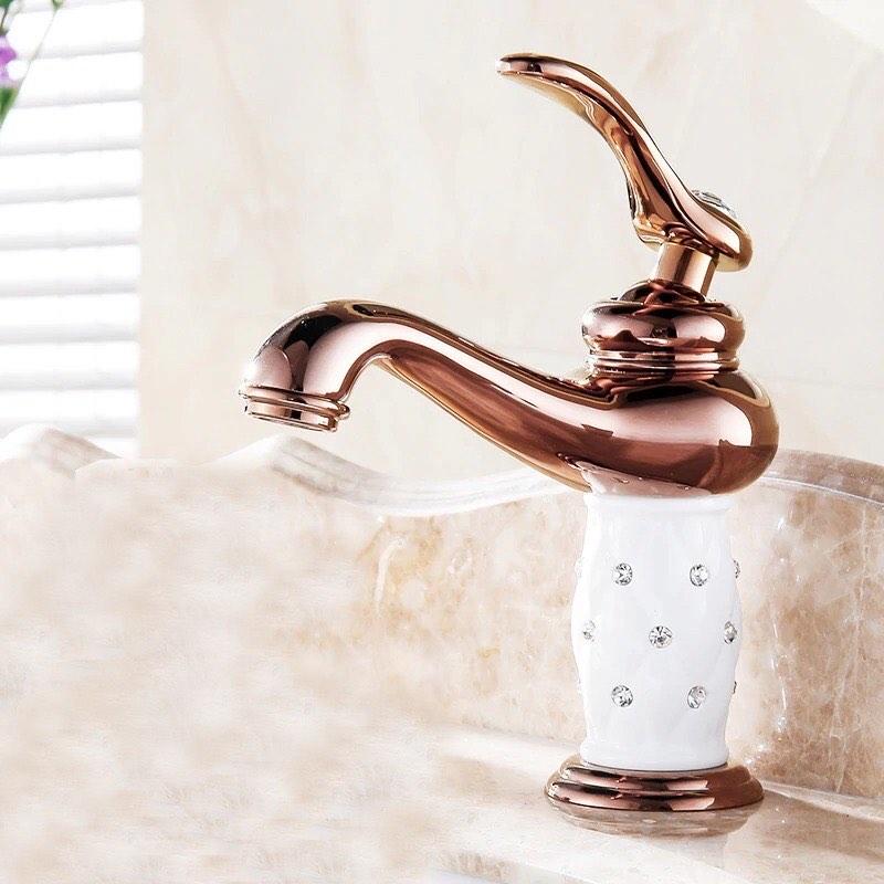 Coco glam faucet - 2 / short - home & office polished rose gold faucet set against the white bejewelled ceramic core. Beige marble counter contrasts making the deep rose a more stunning fixture
