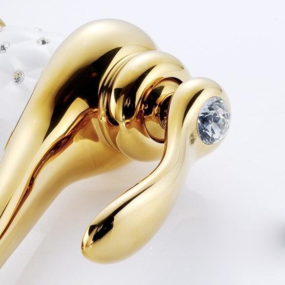 Coco glam faucet - home & office. Close up of sparkling crystal set in the levr of the gold mixer tap. White ceramic core matches the stark white background for a clean elegant look 