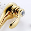 Coco glam faucet - home & office. Close up of sparkling crystal set in the levr of the gold mixer tap. White ceramic core matches the stark white background for a clean elegant look 
