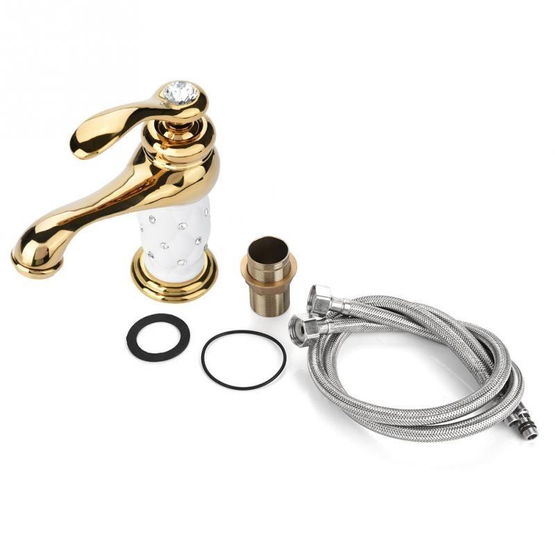 Coco glam faucet - home & office. Unassembled components of the easy to install DIY tap. Connector tubes, O-ring, rubber washer, stem joint and gold on white Coco Glam faucet head shown against stark white surface