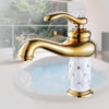 Coco glam faucet - home & office. Composite image of the gold on white short faucet against a white sink in an outdoor room or annex.